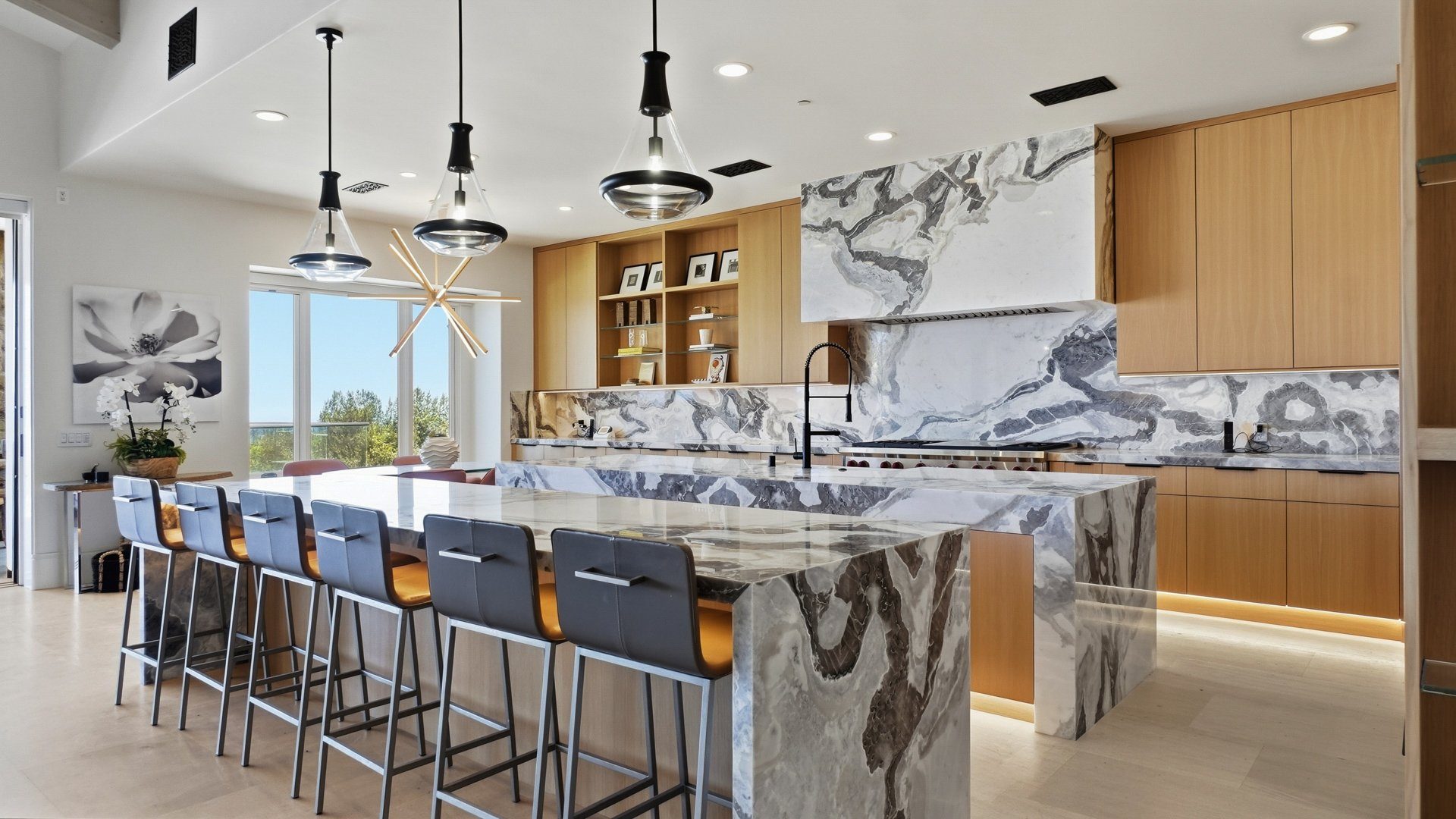 The kitchen island in Dover White stone, with seating along one side.