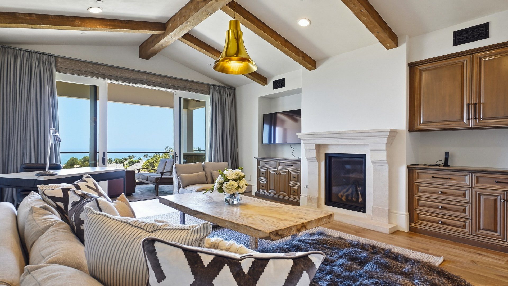 The upstairs family room, with a fireplace and an ocean view.