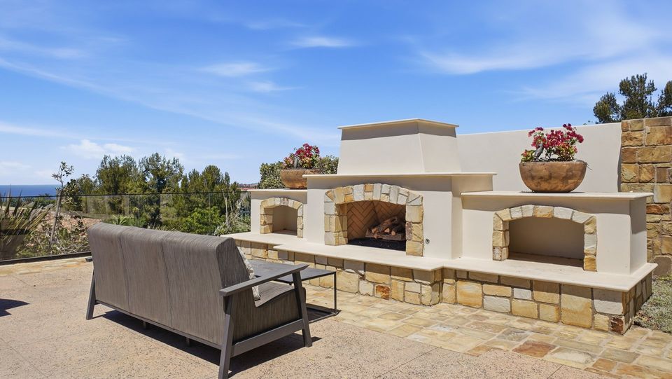 The outdoor fireplace with seating.