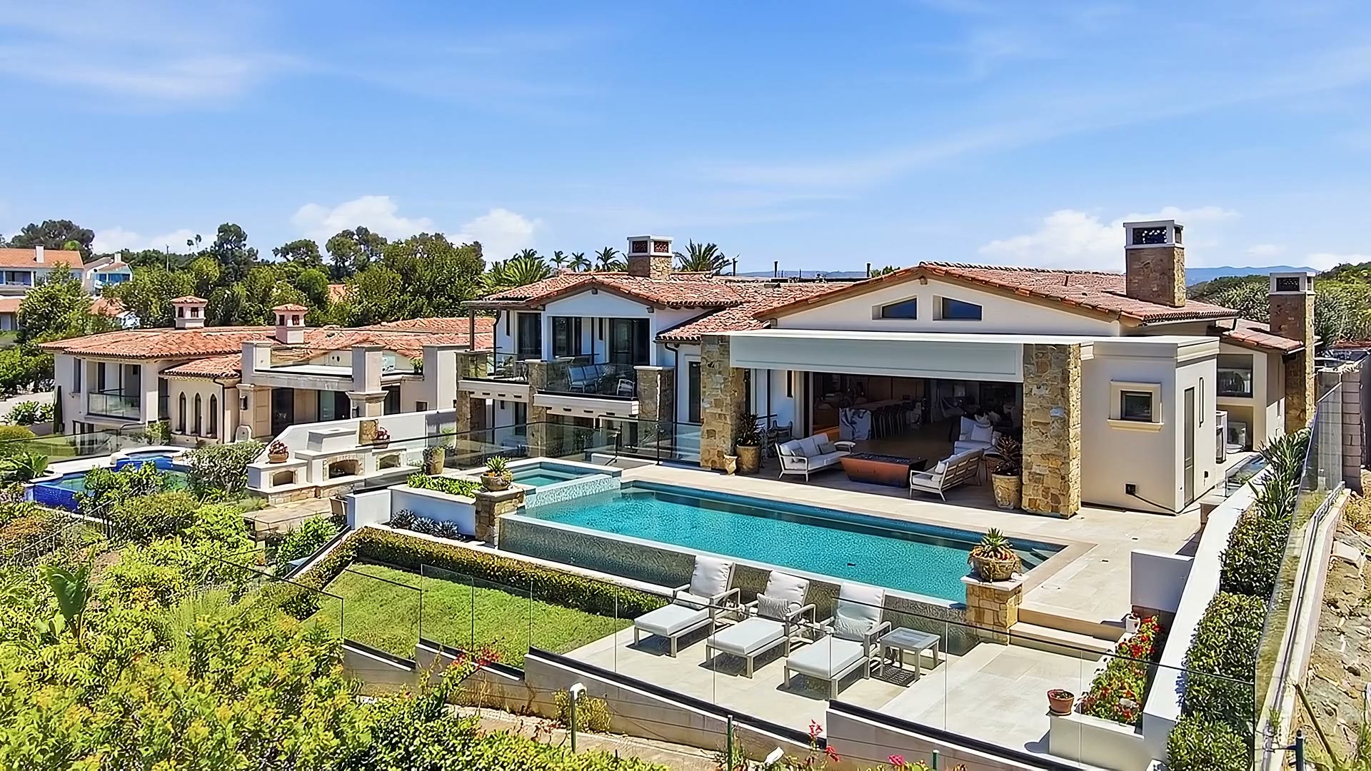 The house and pool from above, with the neighborhood and hills beyond.